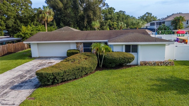 ranch-style house featuring a front lawn and a garage