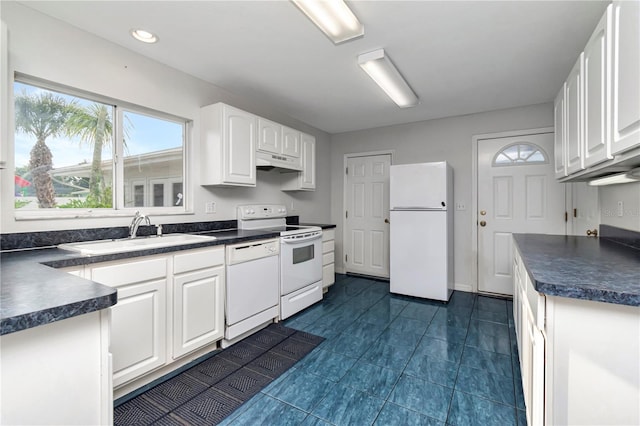 kitchen featuring white cabinetry, sink, ventilation hood, white appliances, and dark tile patterned flooring