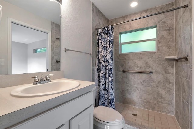 bathroom featuring vanity, toilet, and walk in shower