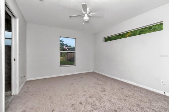 interior space with ceiling fan and light colored carpet