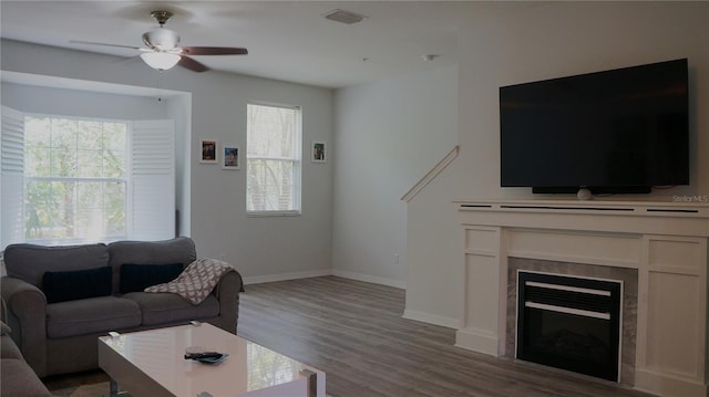 living room with hardwood / wood-style flooring and ceiling fan