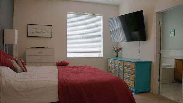 tiled bedroom featuring connected bathroom