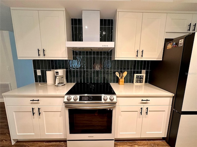 kitchen with exhaust hood, backsplash, appliances with stainless steel finishes, and white cabinetry