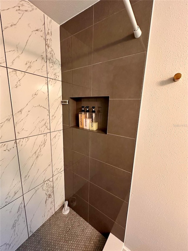 bathroom with tiled shower