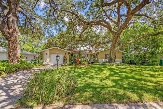 single story home with a garage and a front yard