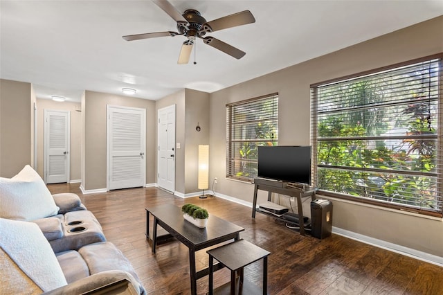 living room featuring dark wood-type flooring, a wealth of natural light, and ceiling fan