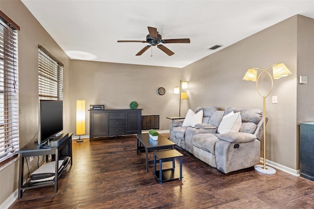 living room featuring ceiling fan and dark wood-type flooring