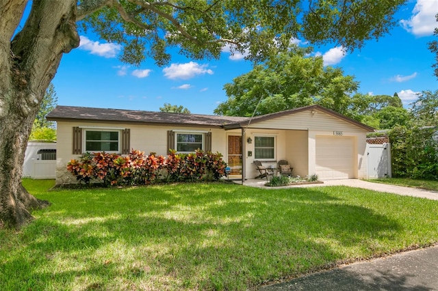 ranch-style home with a front lawn and a garage