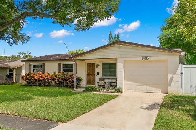 ranch-style house with a garage and a front lawn