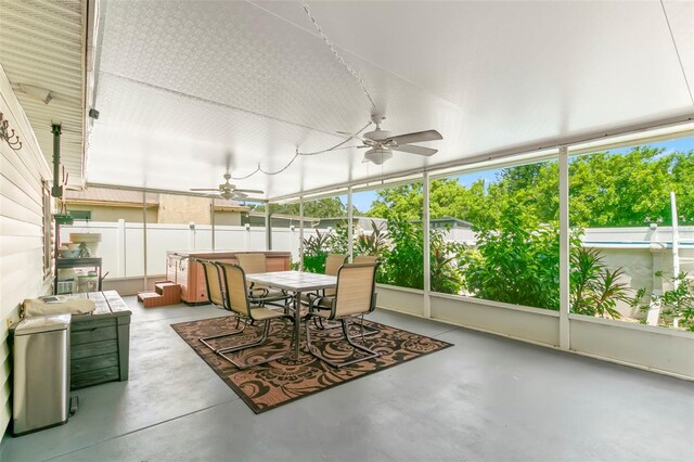 sunroom featuring ceiling fan and a healthy amount of sunlight