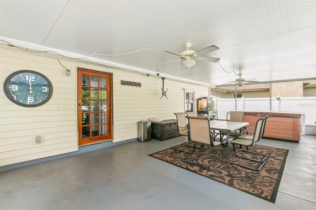 exterior space with ceiling fan and a hot tub