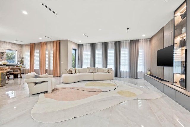 living room featuring recessed lighting, marble finish floor, and visible vents