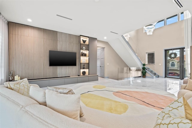 living area featuring stairway, visible vents, marble finish floor, and recessed lighting