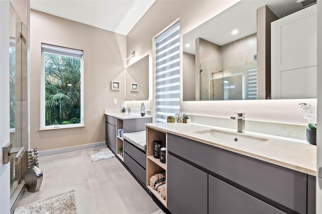 bathroom with double sink vanity, an enclosed shower, and tile patterned floors