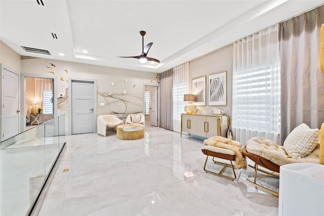 sitting room featuring recessed lighting, a raised ceiling, visible vents, and ceiling fan