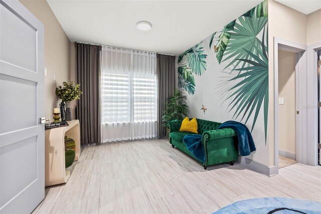 living area featuring baseboards and wood finished floors