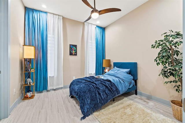 bedroom featuring recessed lighting, wood finished floors, a ceiling fan, and baseboards