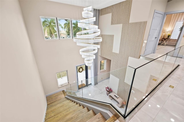 staircase with a chandelier