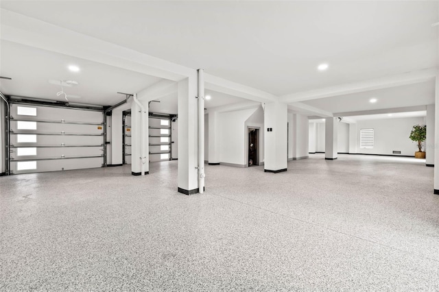 garage featuring recessed lighting and baseboards