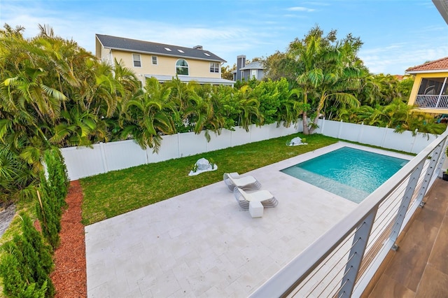 view of swimming pool with a lawn and a patio area