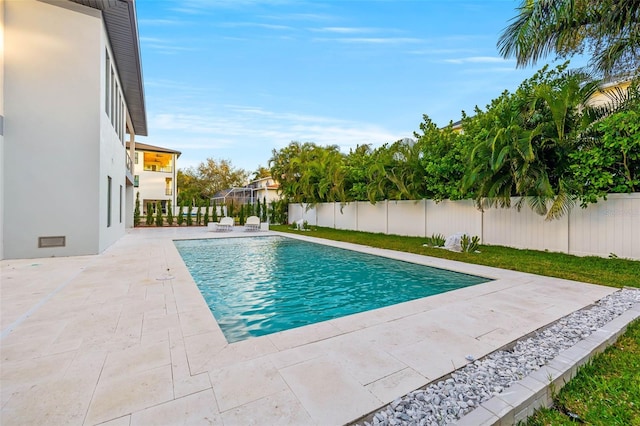 view of swimming pool with a fenced in pool, a patio area, and a fenced backyard