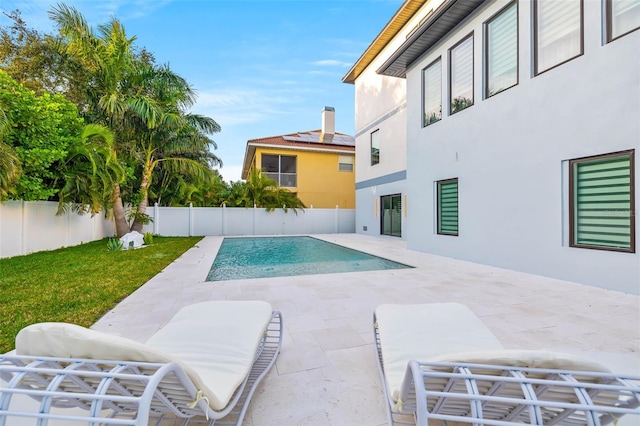 view of pool with a yard, a fenced in pool, a fenced backyard, and a patio