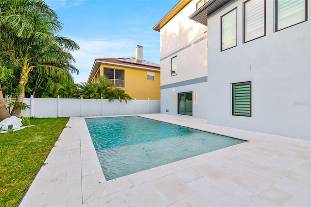 view of swimming pool featuring a lawn, a patio area, a fenced backyard, and a fenced in pool