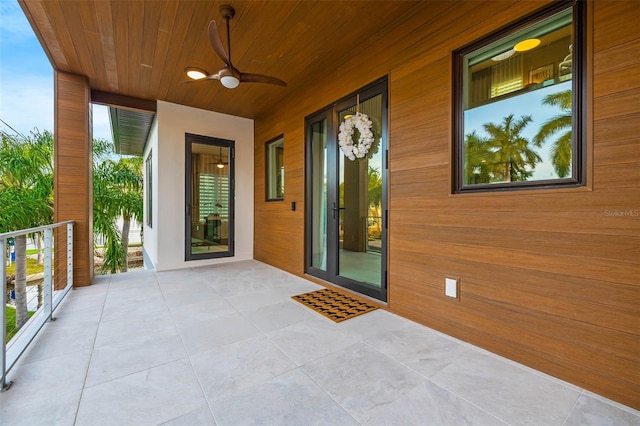 doorway to property featuring a balcony and a ceiling fan