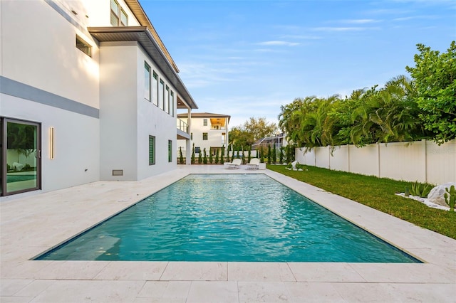 view of swimming pool with a fenced in pool, a fenced backyard, a patio, and a lawn