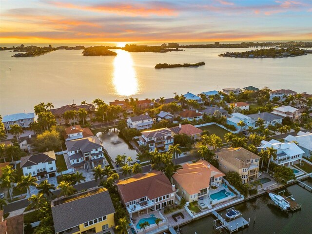 aerial view at dusk with a water view