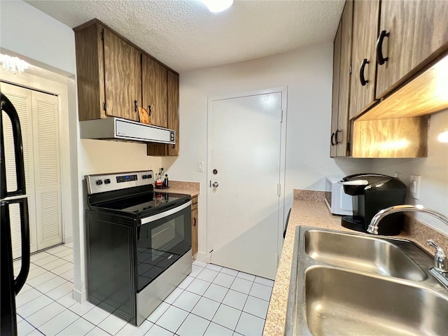 kitchen featuring stainless steel range with electric cooktop, extractor fan, a textured ceiling, sink, and light tile patterned flooring