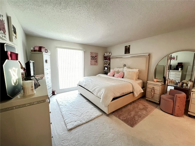 bedroom featuring a textured ceiling and light carpet