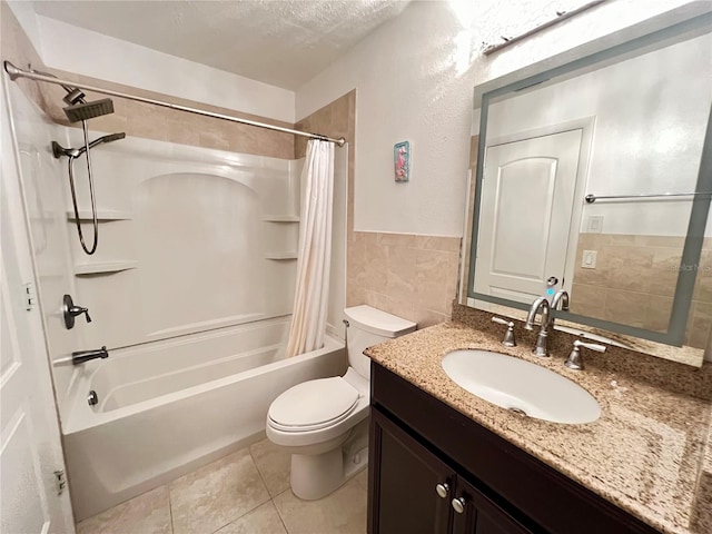 full bathroom featuring shower / tub combo with curtain, a textured ceiling, tile patterned flooring, vanity, and toilet