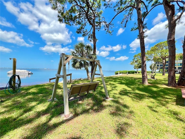 exterior space featuring a boat dock and a water view