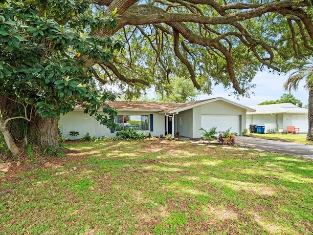 ranch-style home featuring a garage and a front lawn