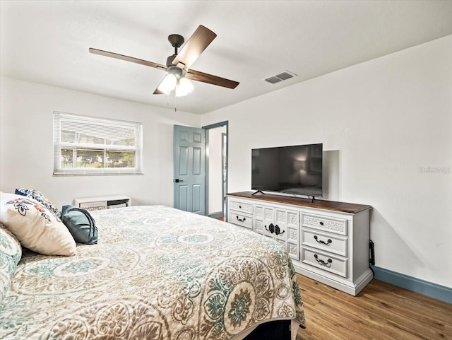 bedroom with ceiling fan and hardwood / wood-style flooring