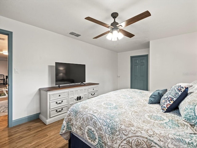 bedroom with light hardwood / wood-style floors and ceiling fan