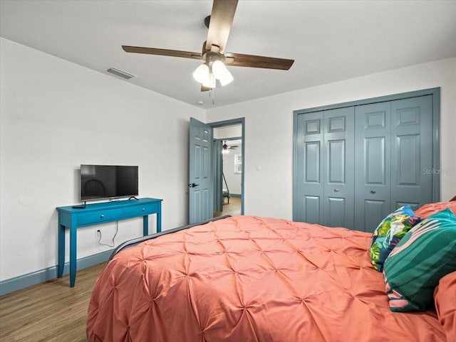 bedroom featuring hardwood / wood-style floors, a closet, and ceiling fan