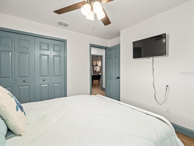 bedroom featuring a closet, ceiling fan, and hardwood / wood-style flooring