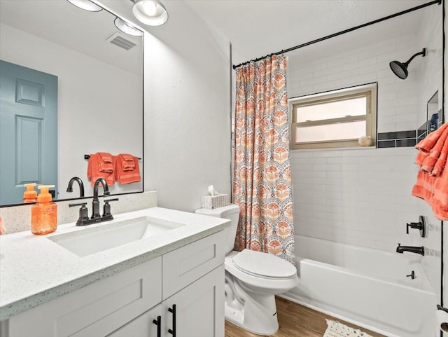 full bathroom featuring hardwood / wood-style floors, toilet, shower / tub combo with curtain, and vanity