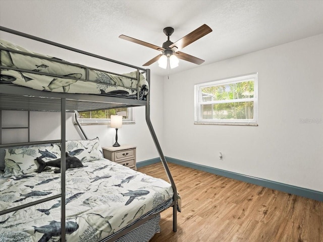 bedroom featuring ceiling fan and hardwood / wood-style flooring