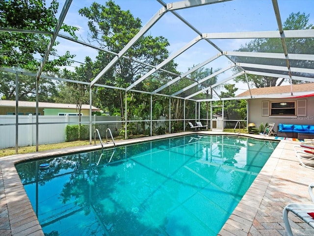 view of swimming pool featuring a lanai