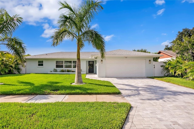 ranch-style house featuring a garage and a front yard