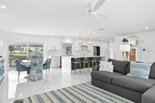 living room with ceiling fan and light tile patterned floors