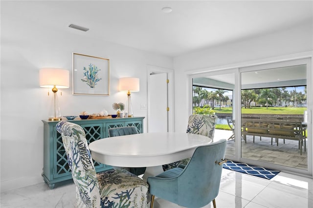 dining space featuring light tile patterned flooring