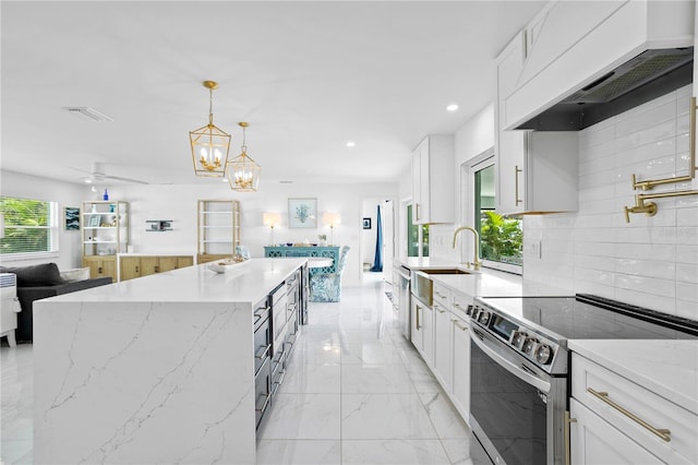 kitchen featuring white cabinetry, stainless steel electric range, custom range hood, and a healthy amount of sunlight