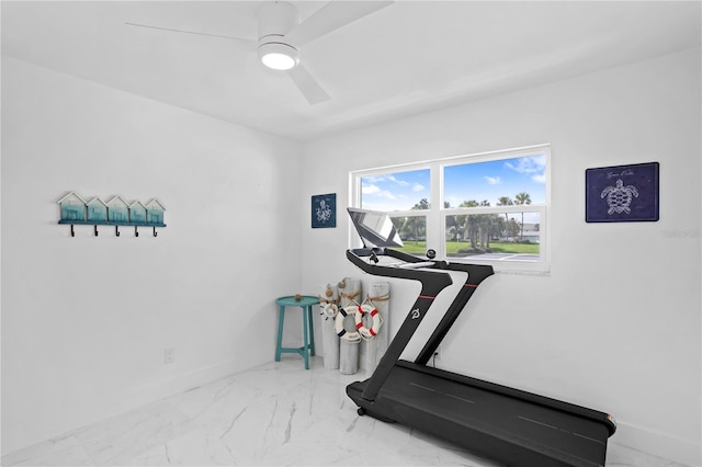 workout area with ceiling fan and tile patterned flooring