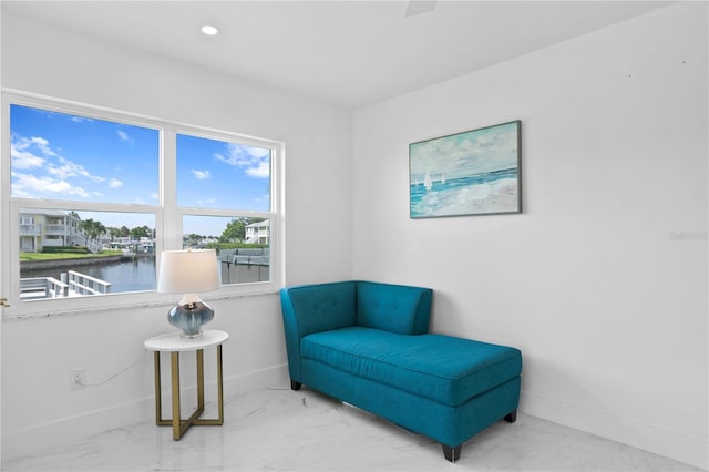 living area featuring a water view