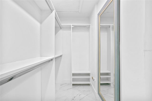 spacious closet with light tile patterned floors