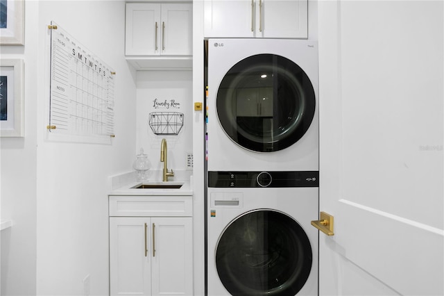 laundry area with stacked washer and dryer, sink, and cabinets